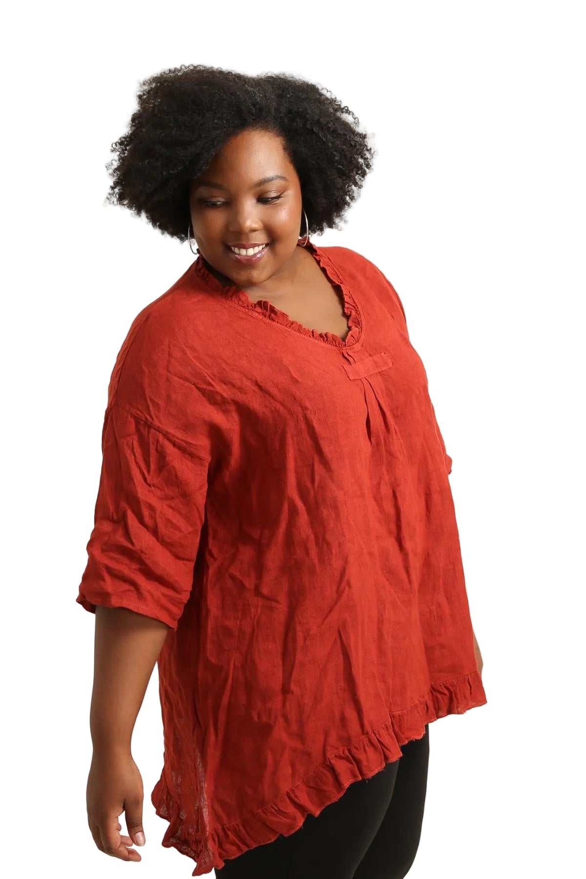Woman wearing a rust top against a white background