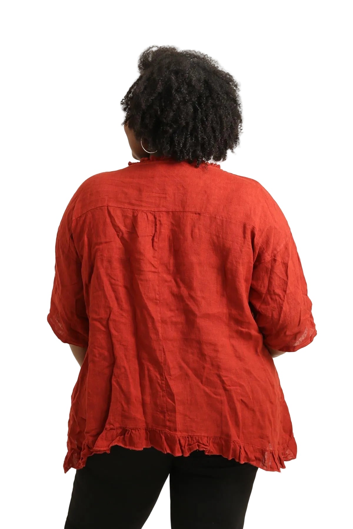 Person wearing a rust top from behind on a white background