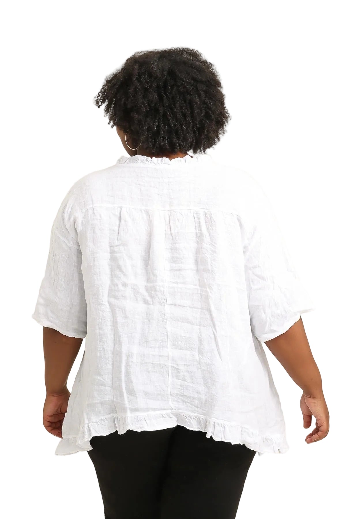 Person wearing a white linen top on a white background