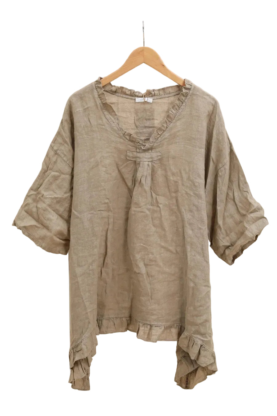 Taupe blouse with ruffled details on a hanger against a white background