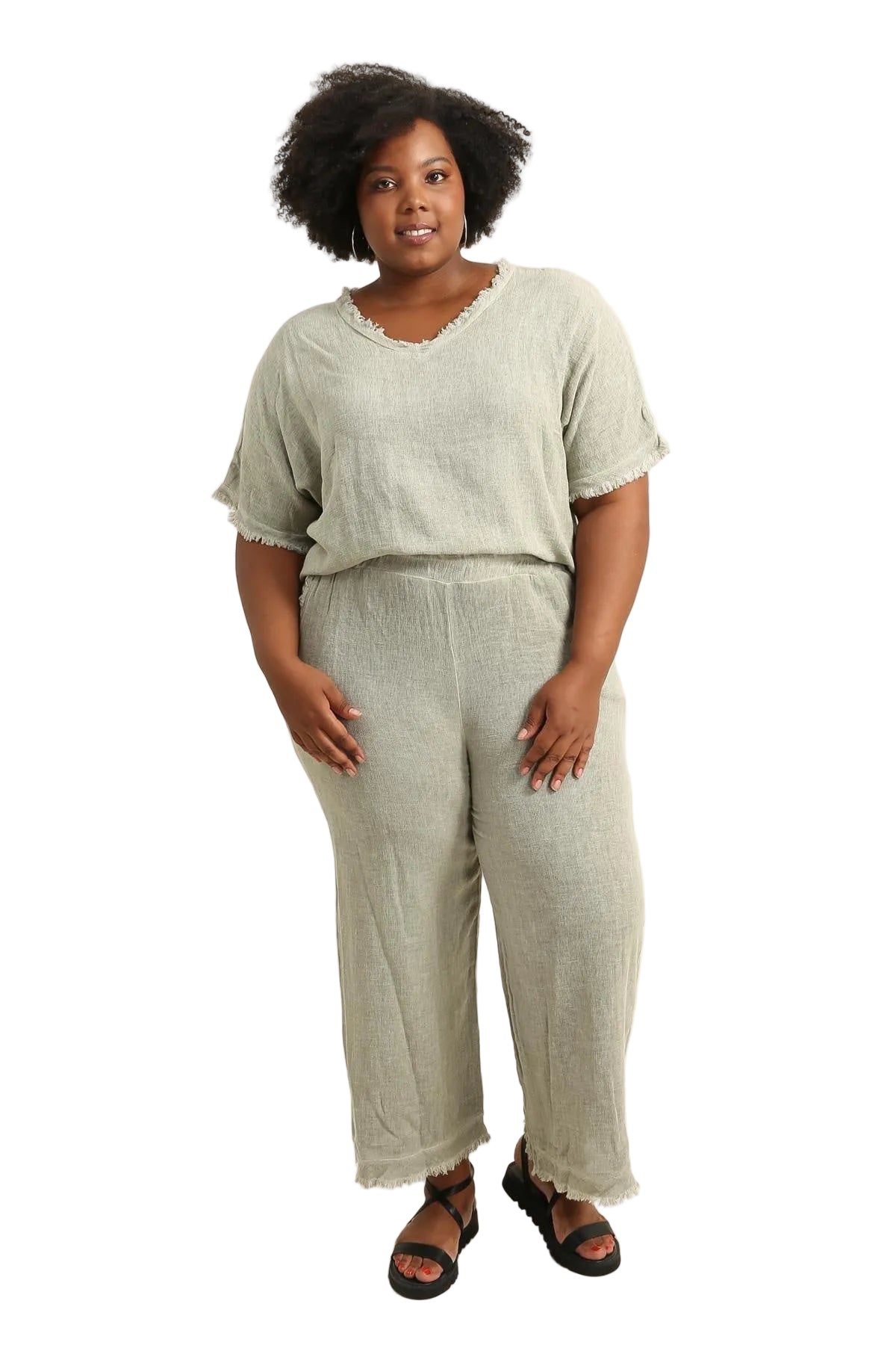 Woman wearing a light green outfit on a beige background