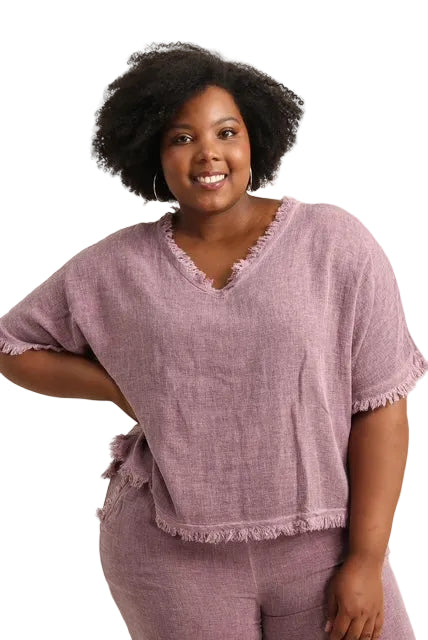 Woman wearing a bordeaux outfit with a plain background