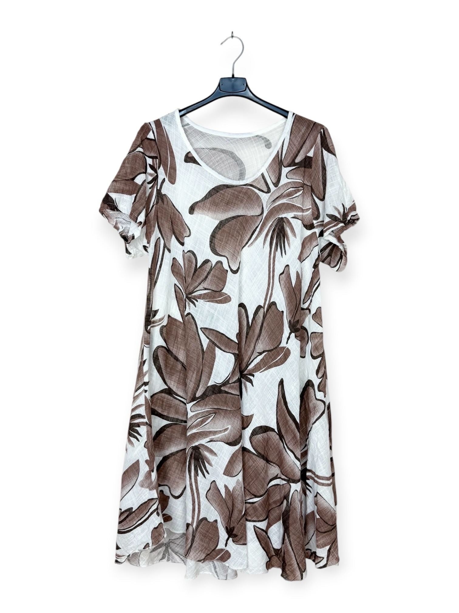 Floral patterned dress on a hanger against a white background