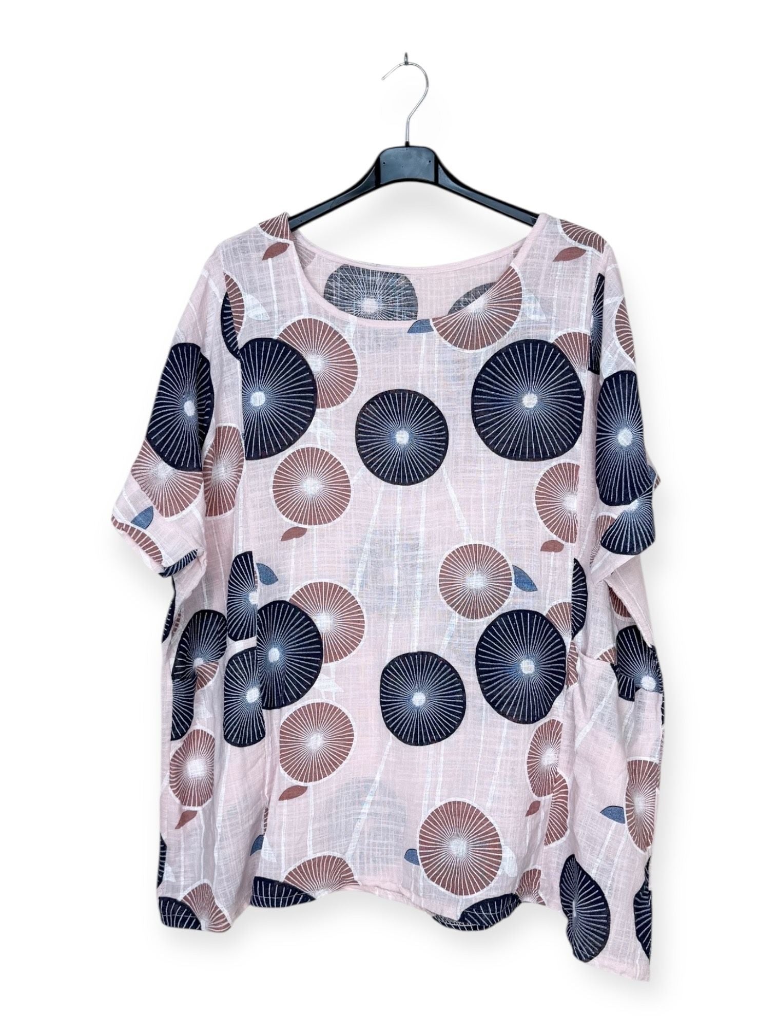 Floral patterned blouse on a hanger against a white background