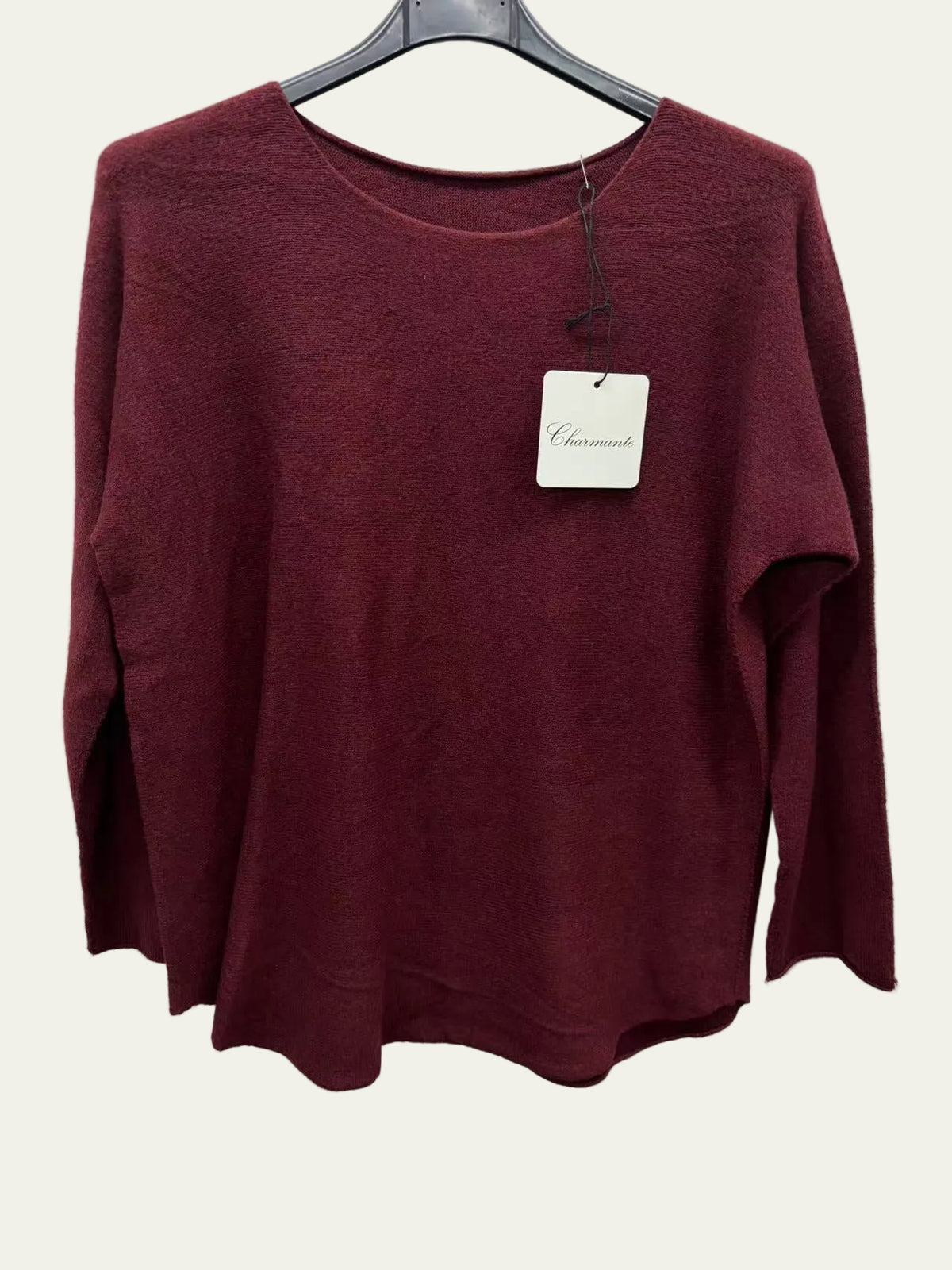 A women's long-sleeve knit sweater in a deep burgundy