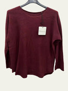 A women's long-sleeve knit sweater in a deep burgundy