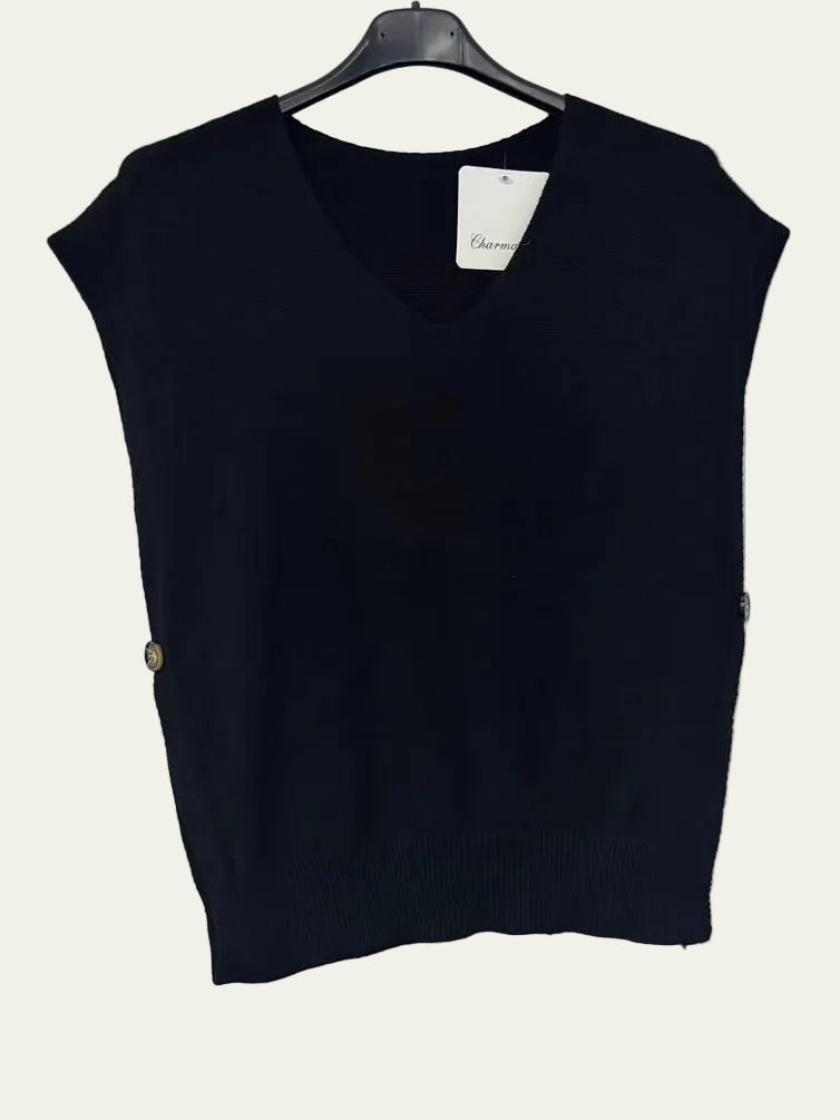 A sleeveless black knit V-neck sweater vest hanging on a black hanger against a plain white wall.