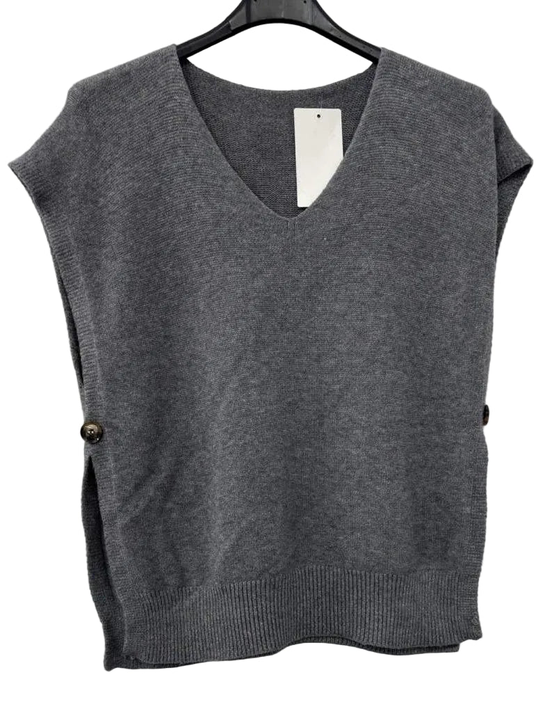 A gray sleeveless knit sweater vest with a V-neck, hanging on a black hanger against a plain white wall. The vest features decorative brown side buttons.