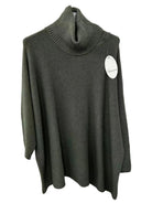 An khaki green knit turtleneck sweater hanging on a white wall, featuring a ribbed high collar and a white circular brand tag on the chest.