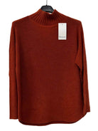 A rust-orange ribbed knit mock-neck sweater 