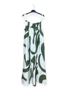 White dress with khaki abstract pattern on a hanger against a white background