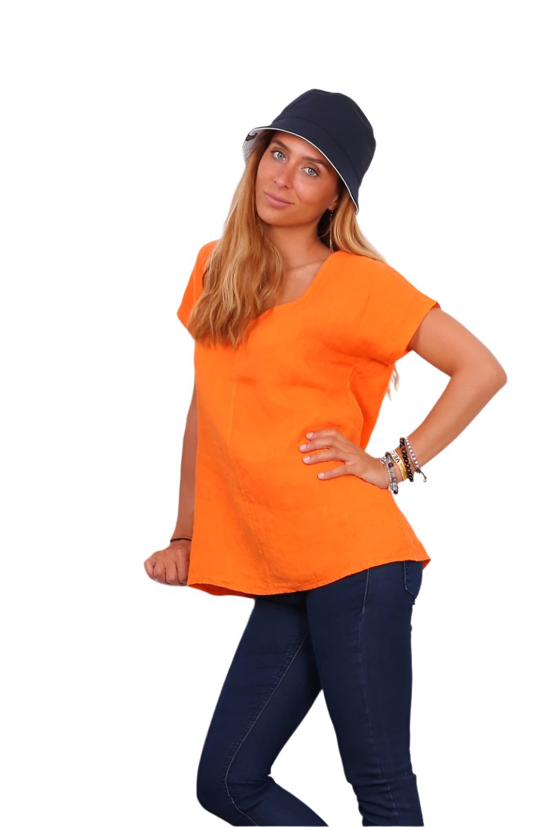 A person wearing a orange v-neck cap sleeve top with a loose fit.