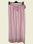 Pink trousers with a tie waist on a hanger 