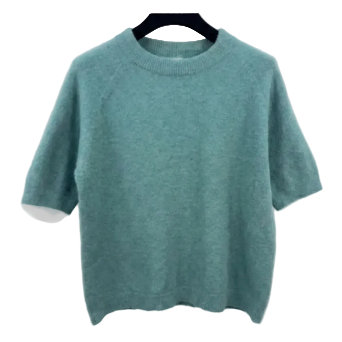 Green sweater on a hanger against a white background