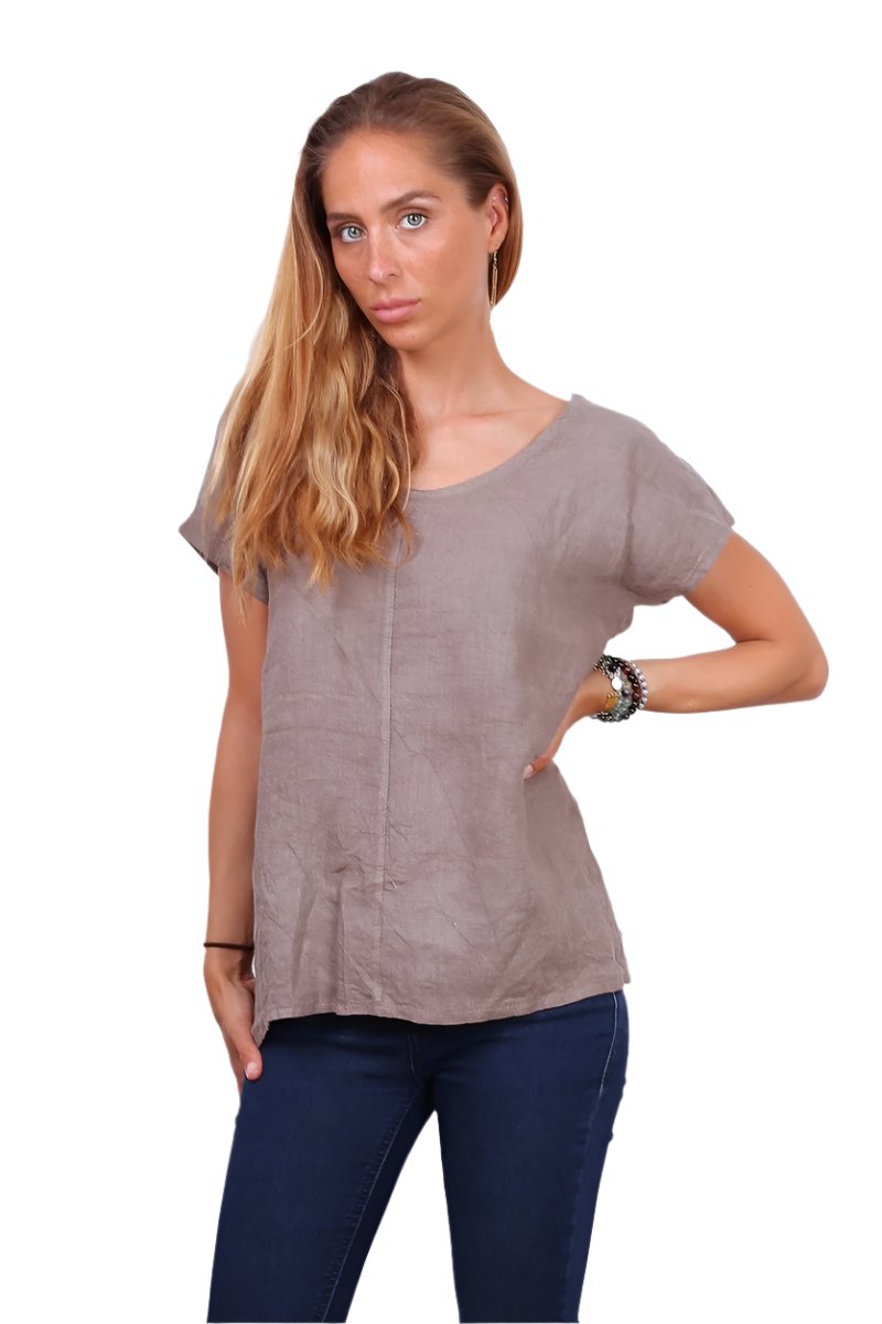 Taupe linen top worn with denim jeans on a white background