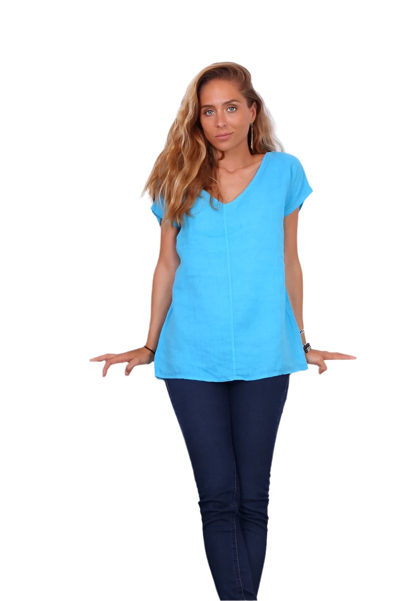 A person wearing a turquoise v-neck cap sleeve top with a loose fit.