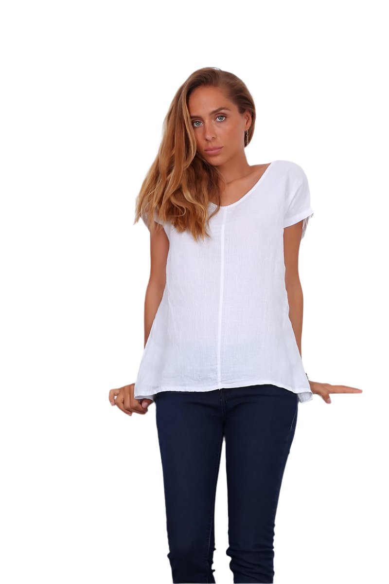 White linen top worn with dark blue jeans on a white background