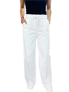 Person wearing white pants on a white background
