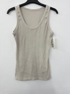 Beige tank top on a hanger against a white background