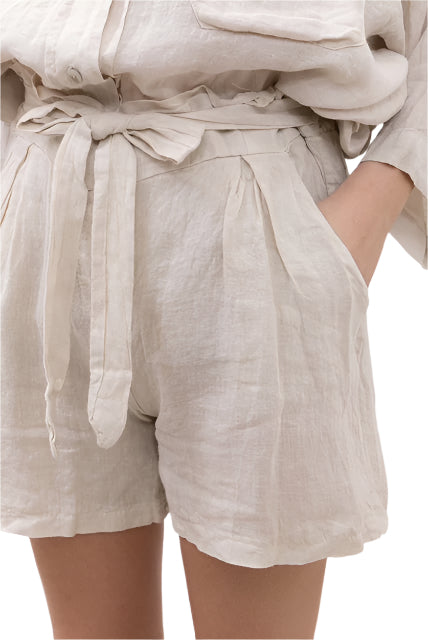 Beige linen shorts with a tie waist on a white background