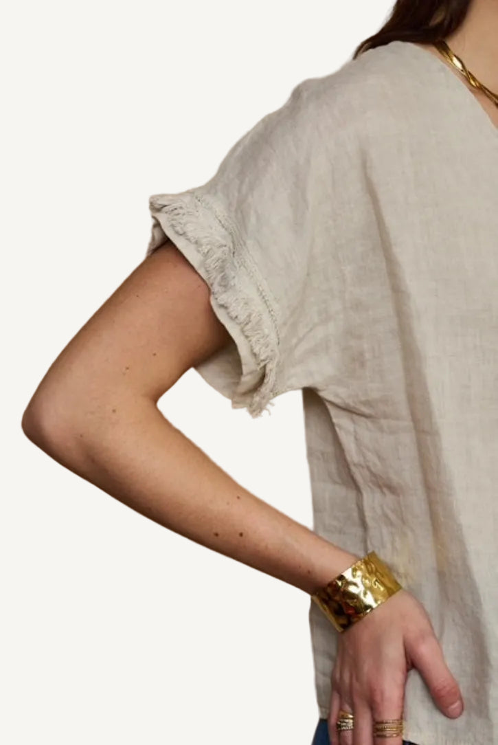 beige linen top with fringe detail to sleeve
