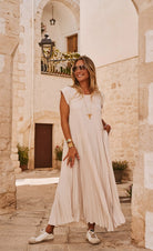 beige pleated dress