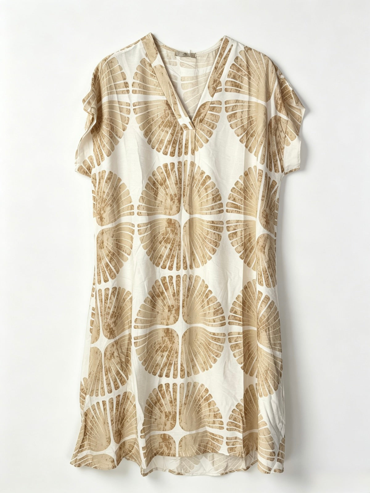 A short-sleeve V-neck dress featuring an all-over beige and cream circular fan-like pattern, displayed flat against a light off-white background.