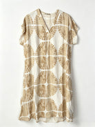 A short-sleeve V-neck dress featuring an all-over beige and cream circular fan-like pattern, displayed flat against a light off-white background.