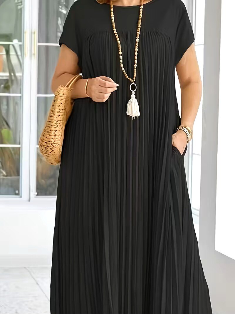 close up of black cap sleeve pleated dress