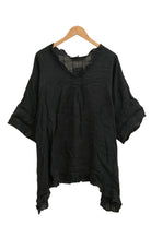 Black shirt on a hanger against a white background