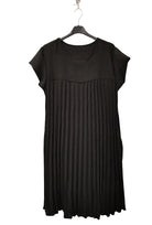 black pleated dress on plain background
