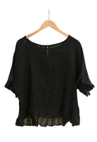Black ruffled blouse on a white background
