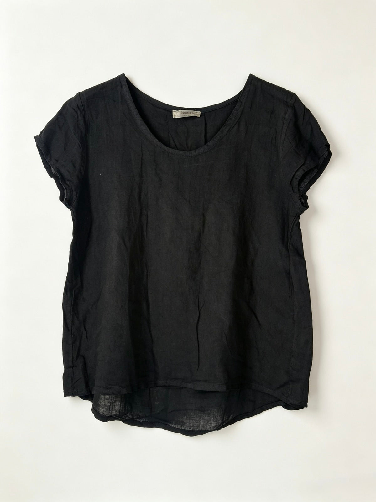 Black linen top on a white background