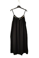 black strappy dress on plain background