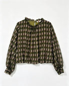 A long-sleeve blouse with a green, brown, and beige plaid pattern, featuring a ruffled high neckline and gathered cuffs, laid flat against a white background.