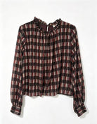 A long-sleeve plaid blouse with a ruffled high neck and gathered cuffs, featuring a checkered pattern of dark brown, black, and muted red on a white background.