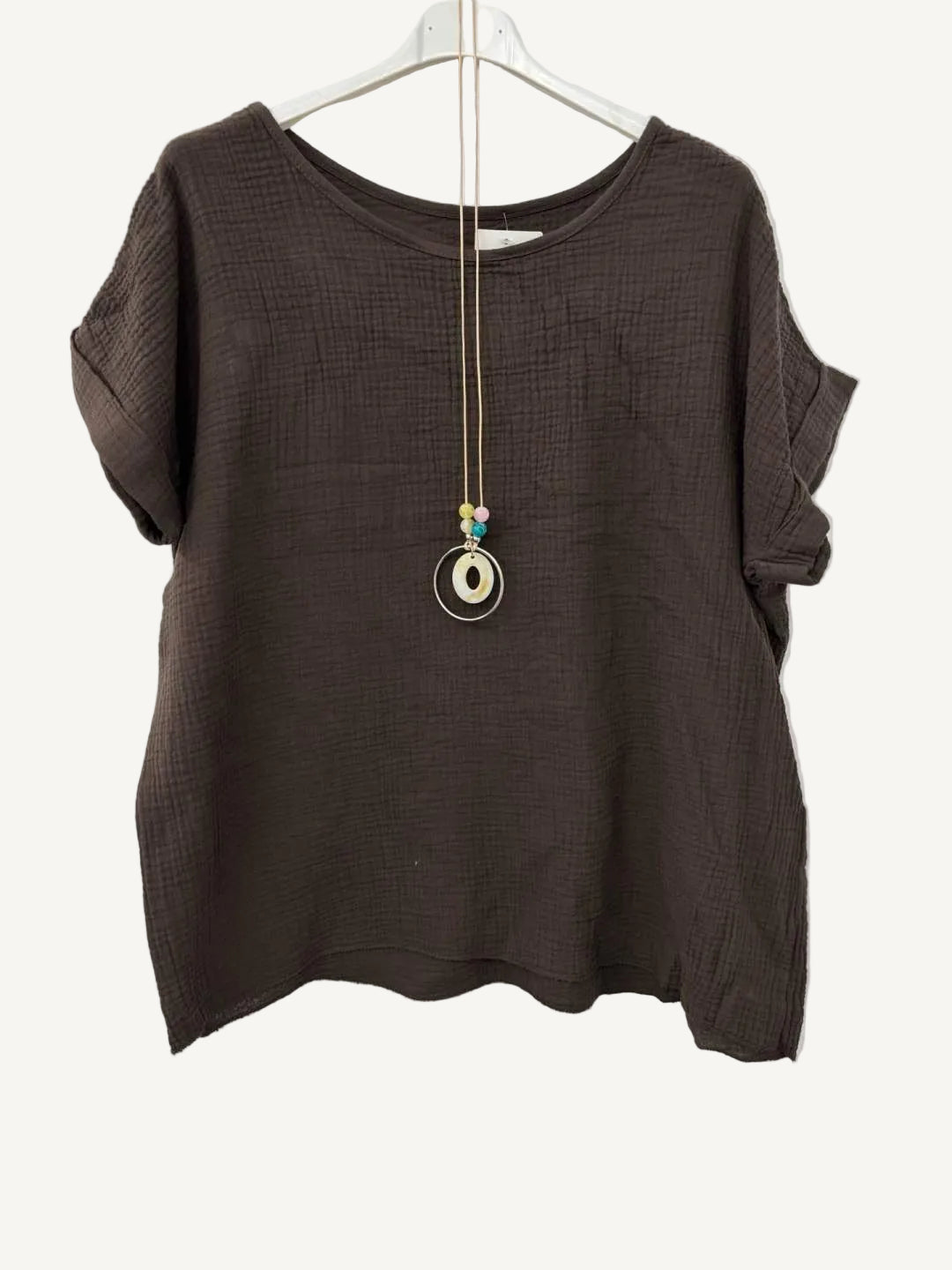 Brown textured top on a hanger with a necklace