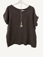 Brown textured top on a hanger with a necklace