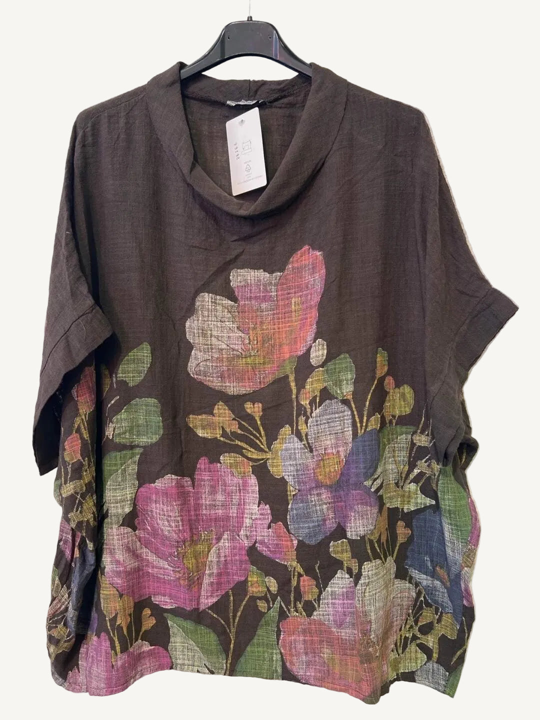 Brown top with floral patterns on a hanger against a white background