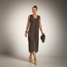 A woman modeling a sleeveless, dark brown midi dress with v neck