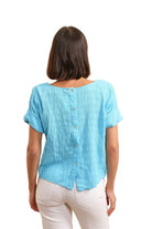 Woman wearing a light blue shirt with buttons 