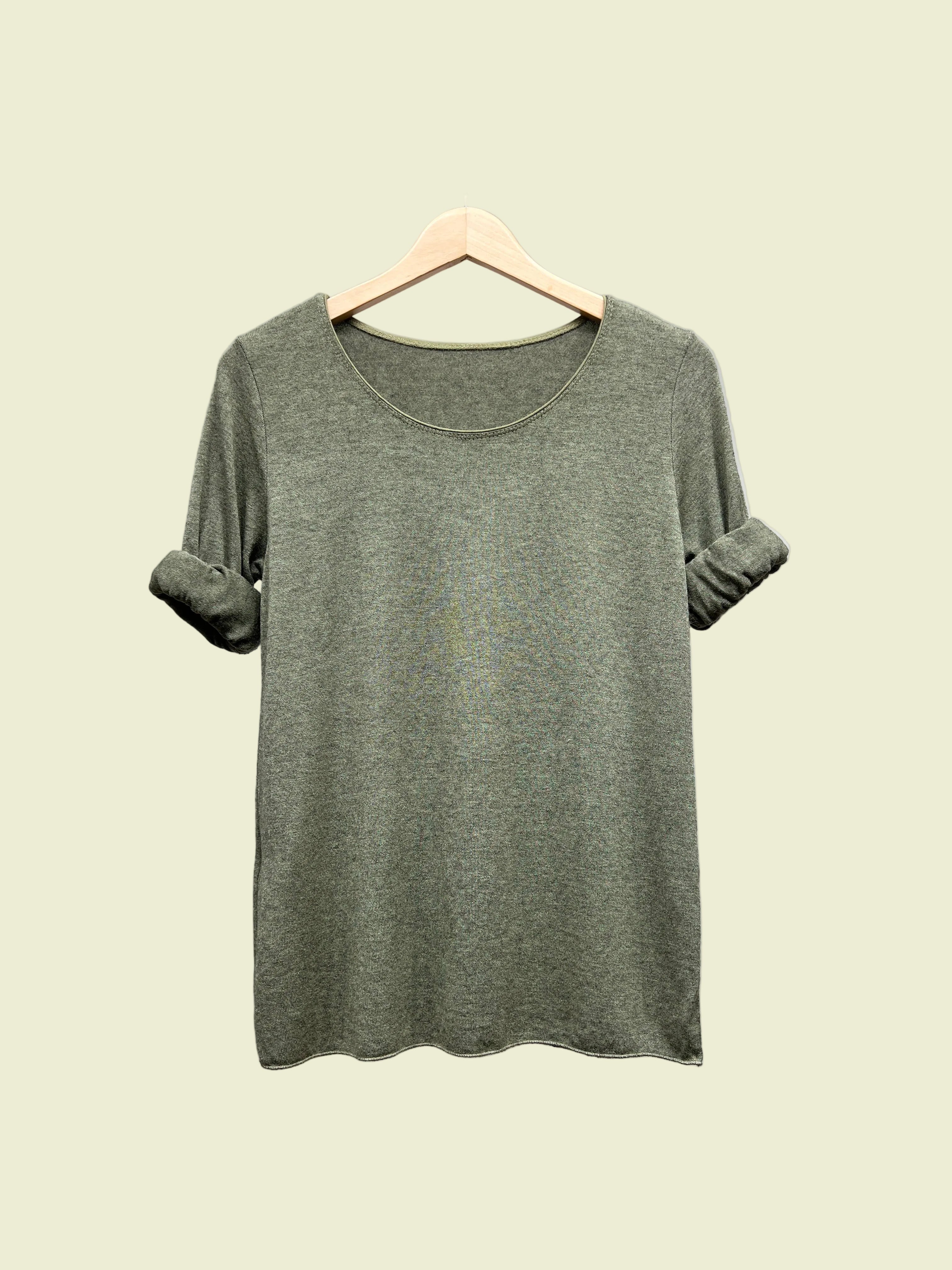 Khaki top on a hanger against a gray background