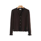 A dark brown knit cardigan sweater with a ruffled trim along the V-neck, button front, and hem,