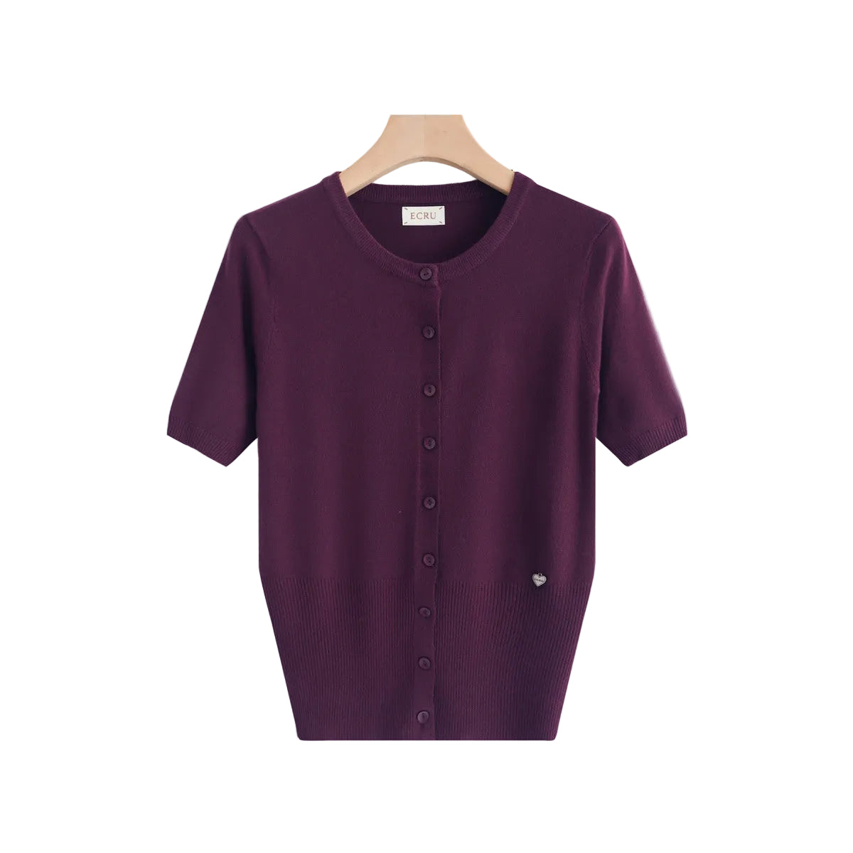 A short-sleeve knit cardigan top in deep plum purple, hanging on a light wood hanger against a clean white background. The cardigan features a round neckline, a front button closure, and a small silver heart detail on the lower right side.