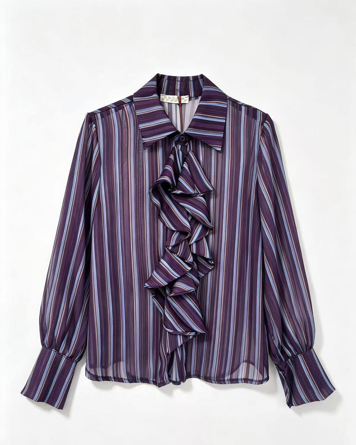 A purple and blue striped long-sleeve blouse with a ruffled front detail, displayed flat against a white background.