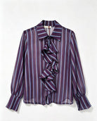 A purple and blue striped long-sleeve blouse with a ruffled front detail, displayed flat against a white background.