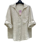 Beige striped shirt on a hanger with a white background