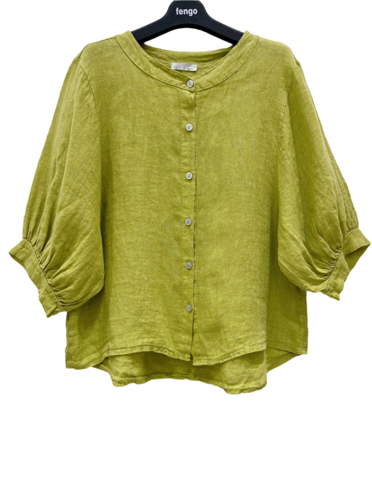 Green shirt on a hanger against a white background
