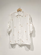 white embroidered shirt with roll up sleeves