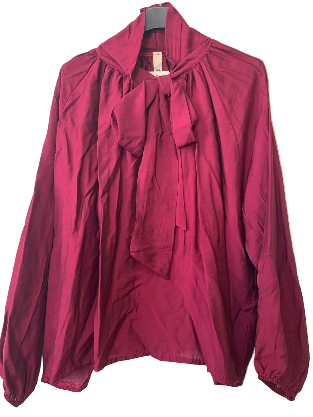 A long-sleeve blouse in deep burgundy with a high collar and a large front bow tie,